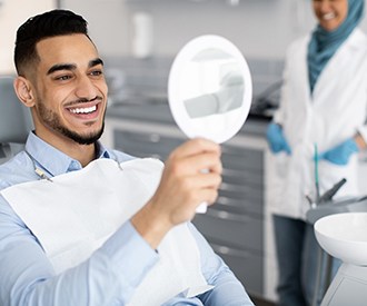 Patient smiling at reflection in mirror