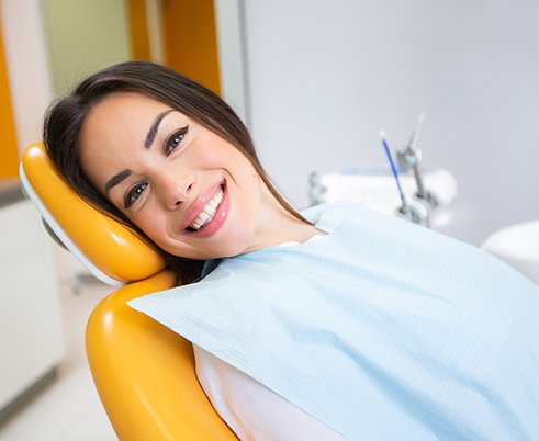 Patient smiling while sitting in treatment chair