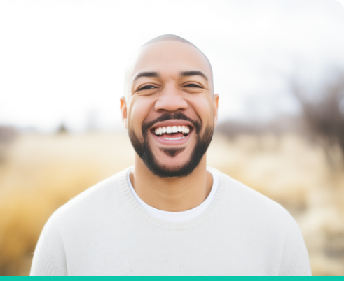 Man in white shirt smiling outside