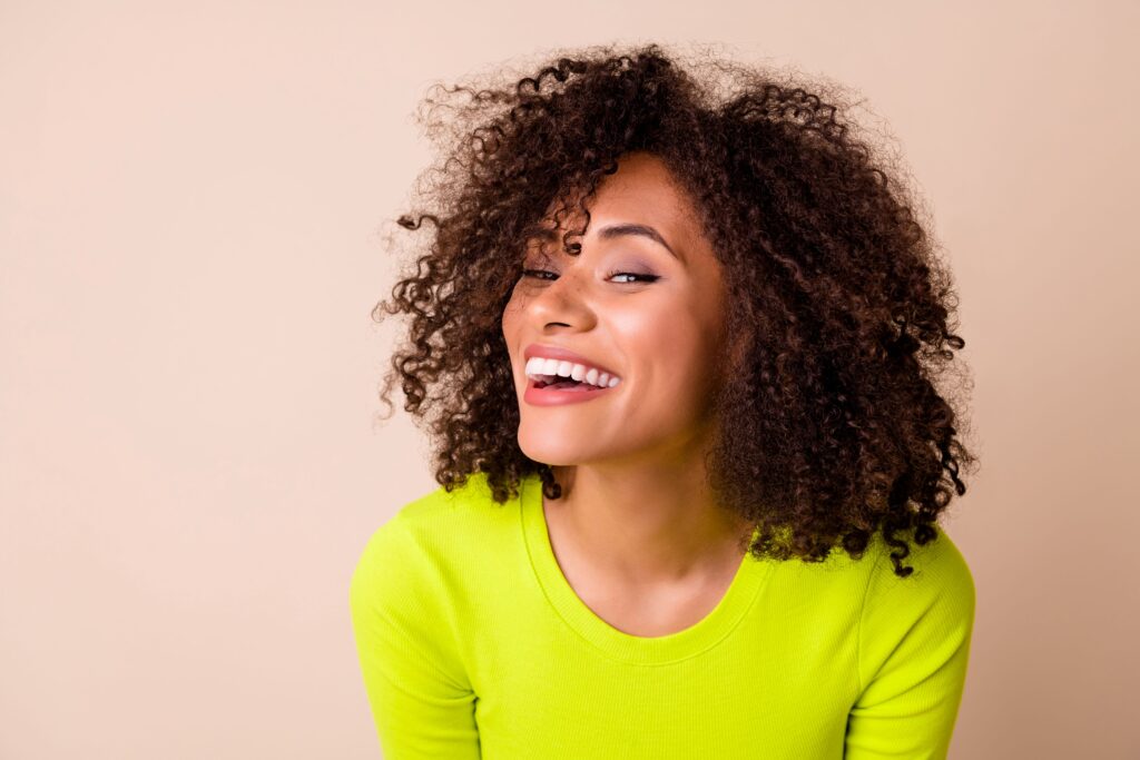 Women in yellow-green sweater smiling 